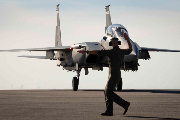 Air Force Master Sgt. Tristan McIntire signals an F-15EX, the Air Force’s newest fighter aircraft, to a stop at Eglin Air Force Base, Fla. March 11, 2021. 